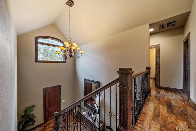 8090 S Homesteader Dr, Morrison, CO 80465 - hall with an upstairs landing, a chandelier, wood finished floors, and vaulted ceiling