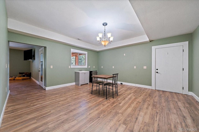8090 S Homesteader Dr, Morrison, CO 80465 - dining area with a chandelier, light wood finished floors, and a tray ceiling