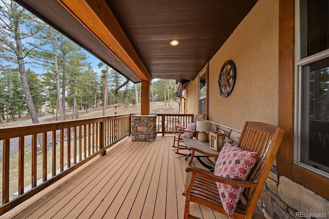 8090 S Homesteader Dr, Morrison, CO 80465 - porch featuring view of wooded area