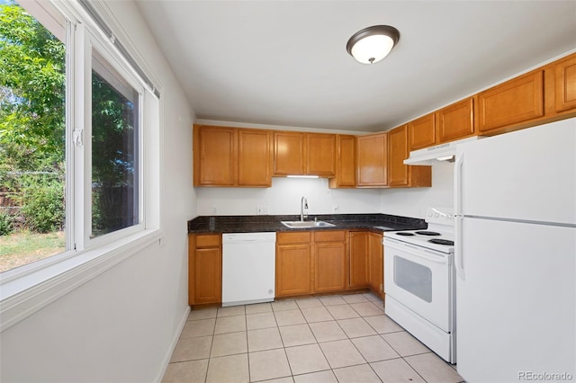 kitchen featuring white appliances, light tile patterned flooring, and sink