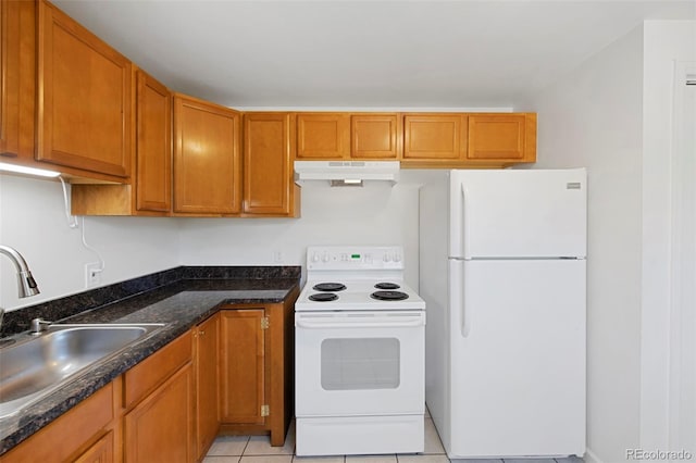 kitchen with sink, light tile patterned floors, white appliances, and dark stone counters