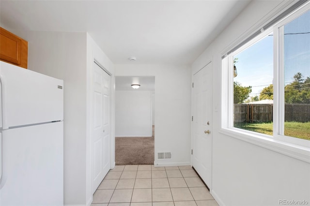 view of carpeted foyer entrance