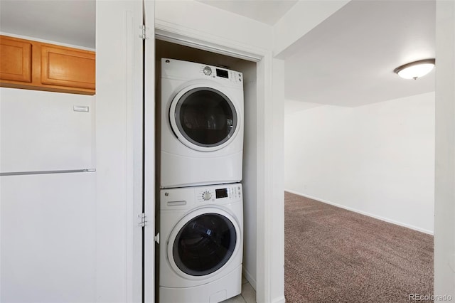 laundry room with light carpet and stacked washer / dryer