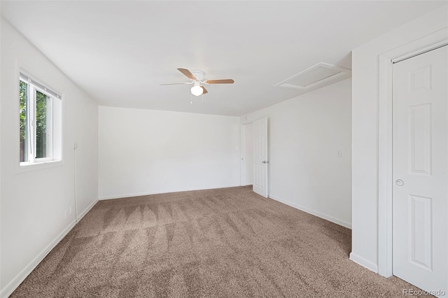 carpeted empty room featuring ceiling fan