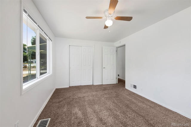 unfurnished bedroom with ceiling fan, a closet, and carpet floors