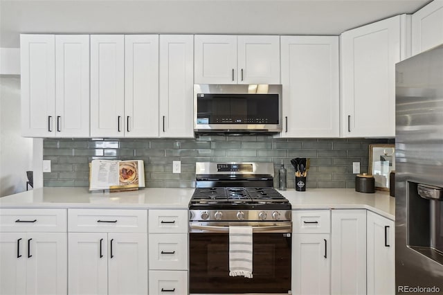 6068 Lee St, Arvada, CO 80004 - kitchen with appliances with stainless steel finishes, light countertops, and white cabinetry