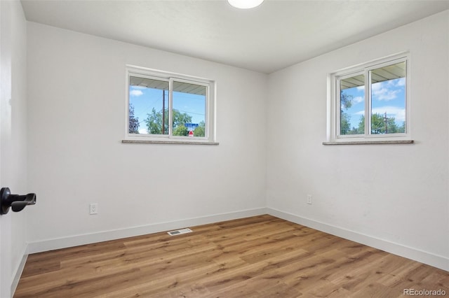6068 Lee St, Arvada, CO 80004 - empty room featuring plenty of natural light, baseboards, and light wood-style floors