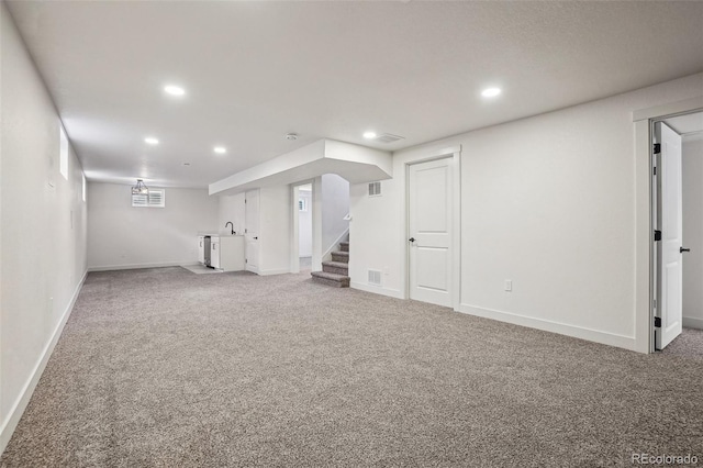 6068 Lee St, Arvada, CO 80004 - finished basement with recessed lighting, carpet floors, stairs, a sink, and baseboards