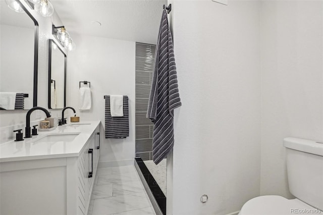 6068 Lee St, Arvada, CO 80004 - bathroom featuring marble finish floors, toilet, double vanity, and baseboards