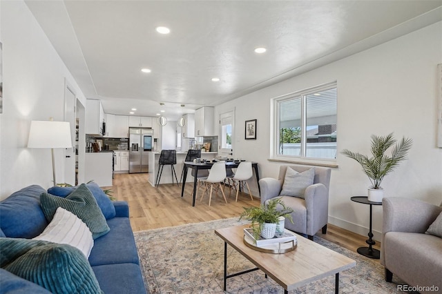 6068 Lee St, Arvada, CO 80004 - living area with light wood-style flooring, recessed lighting, and baseboards