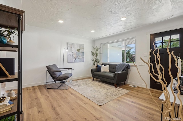 6068 Lee St, Arvada, CO 80004 - living area featuring light wood finished floors, baseboards, and recessed lighting