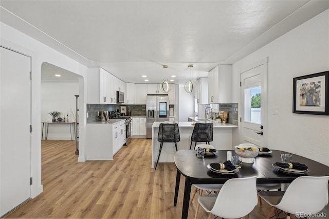 6068 Lee St, Arvada, CO 80004 - dining room with light wood-type flooring and recessed lighting