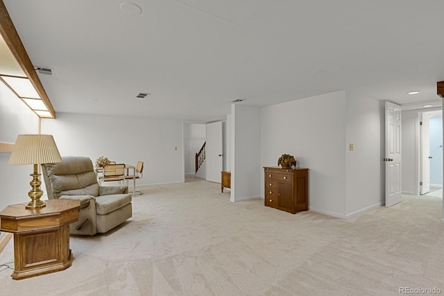 sitting room featuring light colored carpet