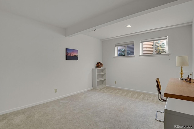 unfurnished office with beam ceiling and light carpet