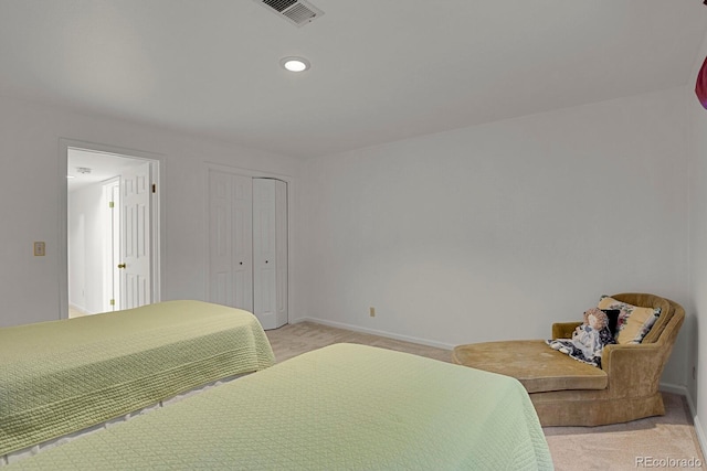 carpeted bedroom featuring a closet