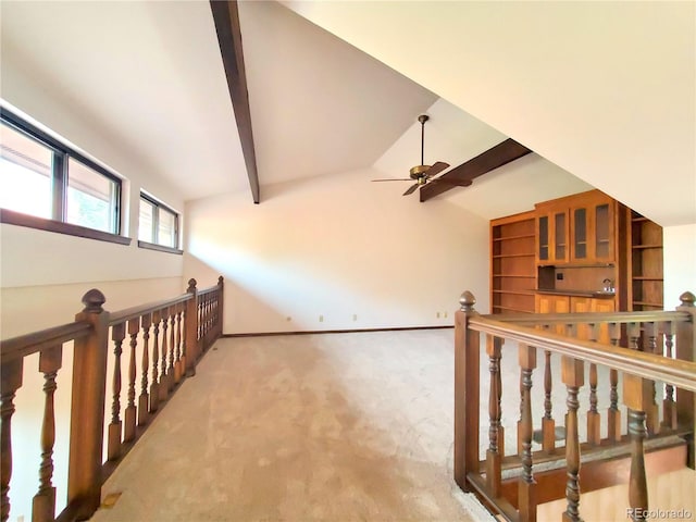 bonus room with carpet flooring, ceiling fan, and lofted ceiling with beams