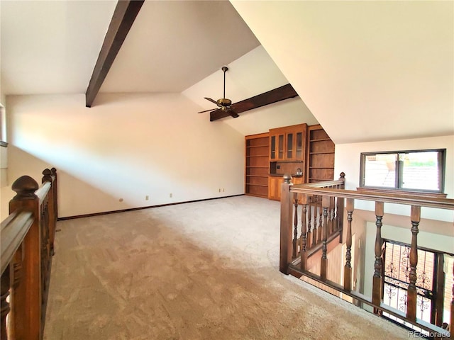 interior space with vaulted ceiling with beams, ceiling fan, and carpet floors