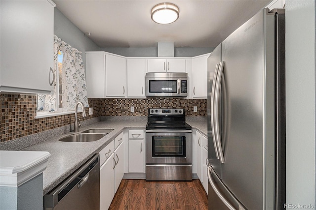 kitchen with dark wood-type flooring, white cabinetry, appliances with stainless steel finishes, and sink