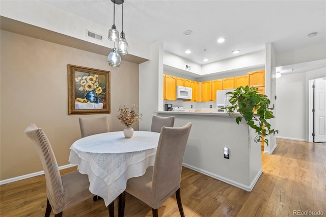 dining space featuring light hardwood / wood-style floors