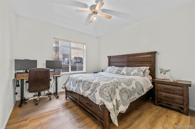 bedroom with ceiling fan and light hardwood / wood-style floors