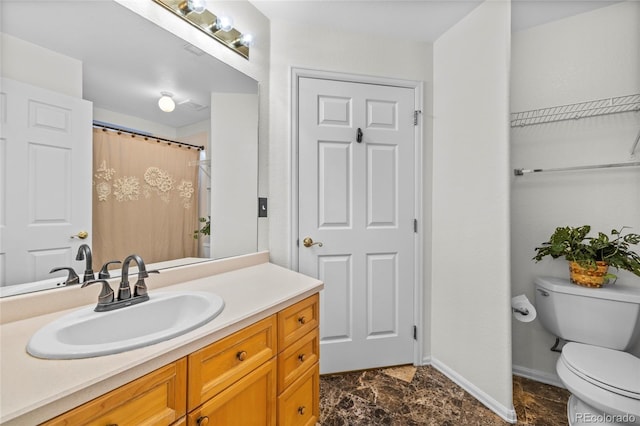 bathroom with vanity and toilet