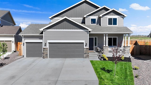 craftsman-style house featuring a garage, covered porch, and a front lawn