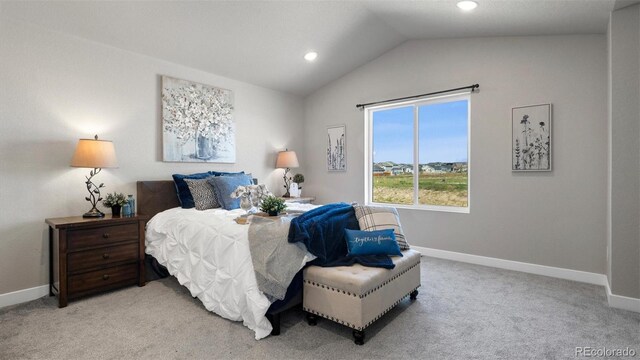 carpeted bedroom with lofted ceiling