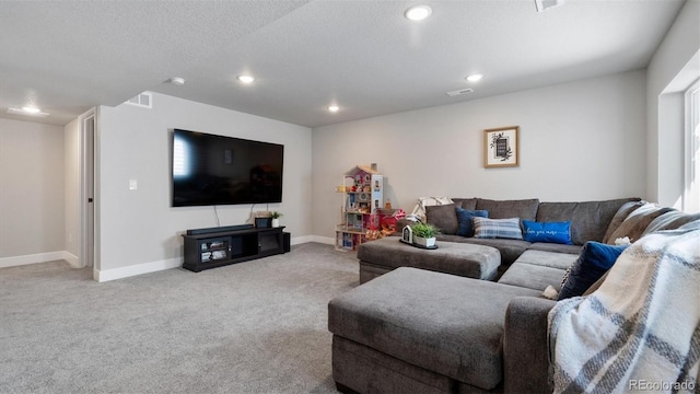 carpeted living room featuring a textured ceiling