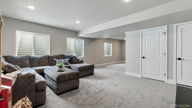 living room featuring light carpet and a textured ceiling