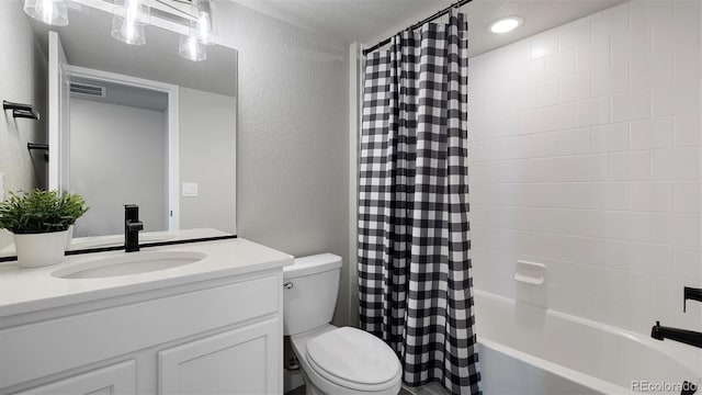 full bathroom with a textured ceiling, vanity, shower / bath combo, and toilet