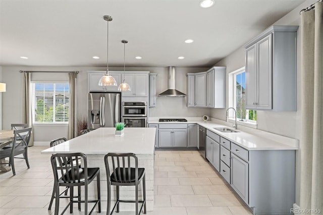 7380 S Shady Grove Way, Aurora, CO 80016 - kitchen with wall chimney range hood, appliances with stainless steel finishes, a sink, gray cabinetry, and healthy amount of natural light