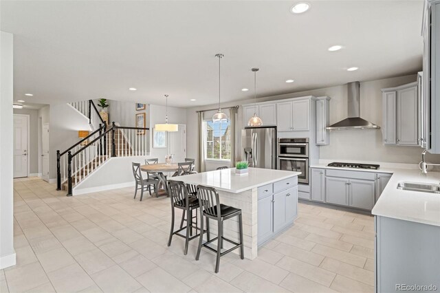 7380 S Shady Grove Way, Aurora, CO 80016 - kitchen with wall chimney range hood, appliances with stainless steel finishes, light countertops, a kitchen breakfast bar, and a kitchen island