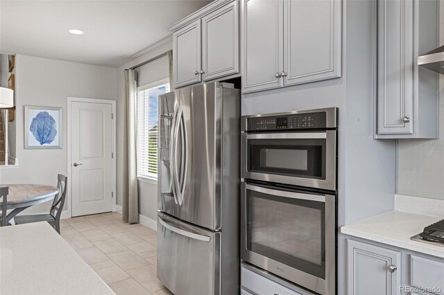 7380 S Shady Grove Way, Aurora, CO 80016 - kitchen featuring appliances with stainless steel finishes, gray cabinets, light countertops, and baseboards