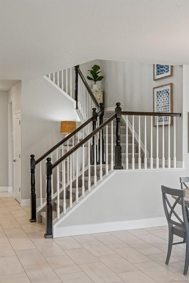 7380 S Shady Grove Way, Aurora, CO 80016 - stairs with tile patterned flooring and baseboards