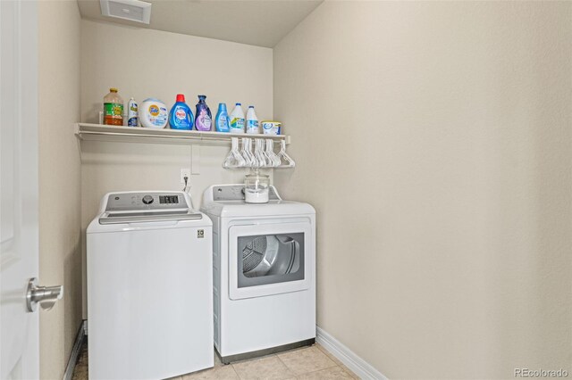 7380 S Shady Grove Way, Aurora, CO 80016 - laundry room featuring separate washer and dryer, light tile patterned floors, and baseboards