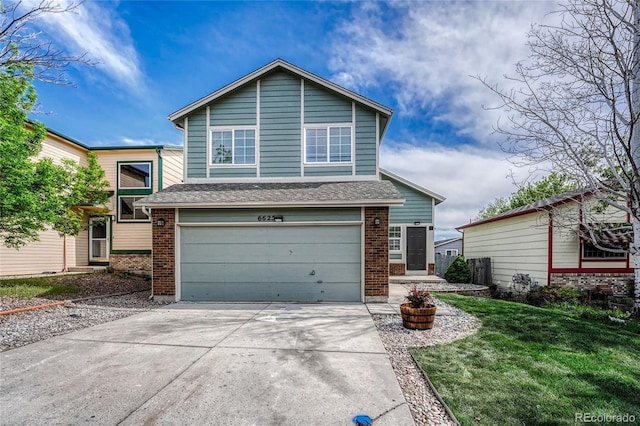 view of front of house with a garage and a front lawn