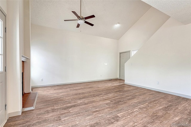 unfurnished living room featuring ceiling fan, wood-type flooring, a textured ceiling, and high vaulted ceiling