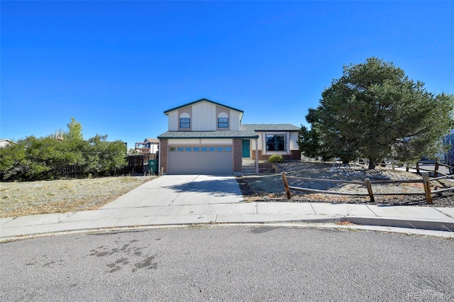 view of front of property with an attached garage, driveway, fence, and brick siding