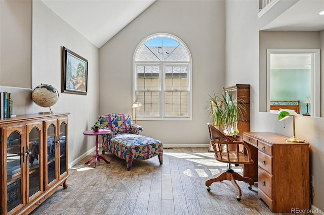 2252 S Yosemite Cir, Denver, CO 80231 - sitting room featuring baseboards, vaulted ceiling, and wood finished floors