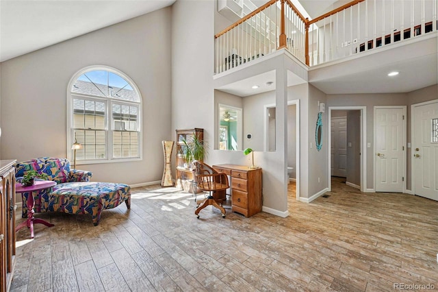 2252 S Yosemite Cir, Denver, CO 80231 - home office with baseboards, wood-type flooring, and a high ceiling