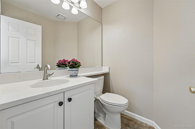 2252 S Yosemite Cir, Denver, CO 80231 - bathroom featuring vanity, baseboards, and toilet
