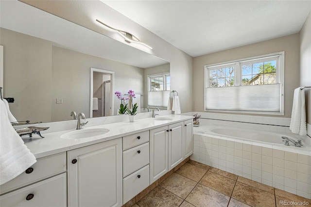 2252 S Yosemite Cir, Denver, CO 80231 - bathroom with a sink, tile patterned floors, a garden tub, and double vanity