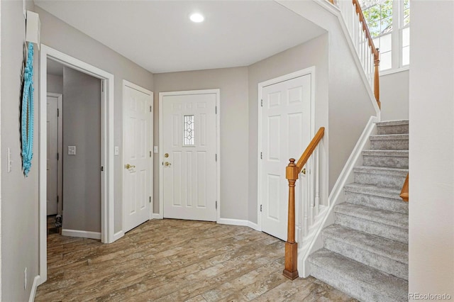 2252 S Yosemite Cir, Denver, CO 80231 - foyer entrance with baseboards, stairs, and wood finished floors