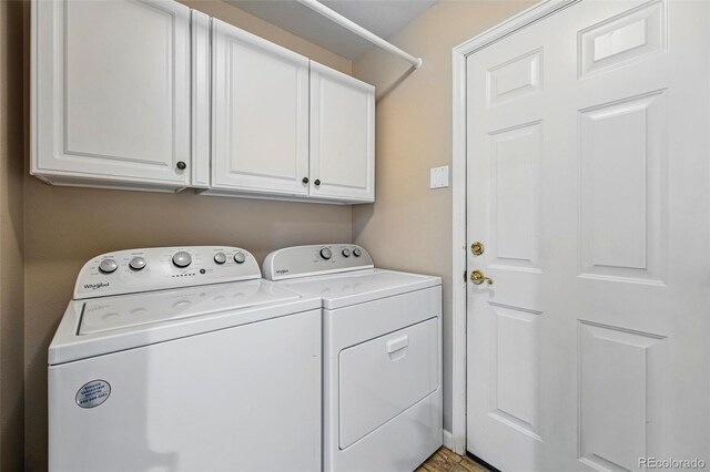 2252 S Yosemite Cir, Denver, CO 80231 - clothes washing area with cabinet space and washing machine and dryer