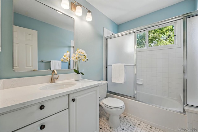 2252 S Yosemite Cir, Denver, CO 80231 - bathroom featuring vanity, bath / shower combo with glass door, and toilet