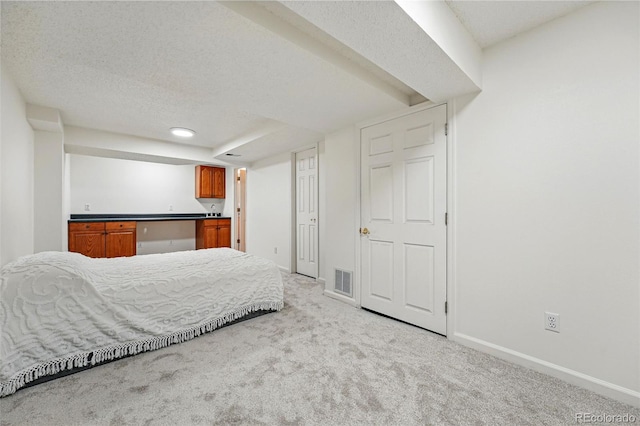 2252 S Yosemite Cir, Denver, CO 80231 - bedroom featuring baseboards, visible vents, a textured ceiling, and light colored carpet