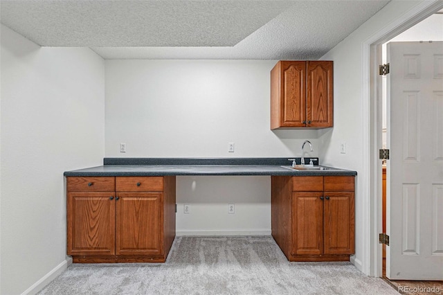 2252 S Yosemite Cir, Denver, CO 80231 - kitchen featuring a sink, dark countertops, light carpet, and brown cabinets