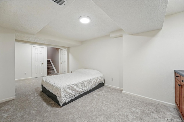2252 S Yosemite Cir, Denver, CO 80231 - carpeted bedroom featuring visible vents, a textured ceiling, and baseboards
