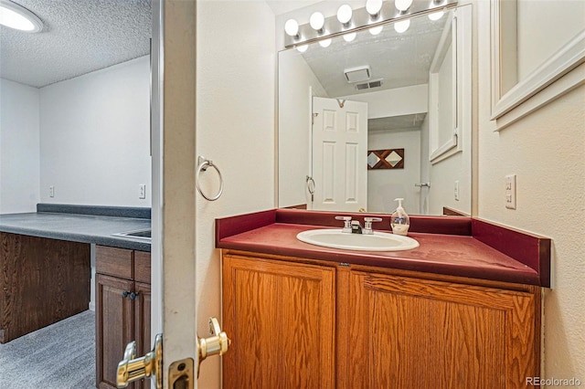 2252 S Yosemite Cir, Denver, CO 80231 - bathroom featuring vanity, a textured ceiling, a textured wall, and visible vents