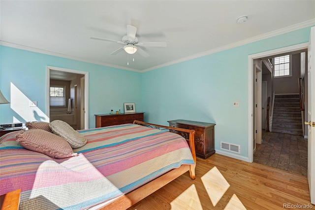 2252 S Yosemite Cir, Denver, CO 80231 - bedroom with crown molding, baseboards, light wood-style flooring, and visible vents